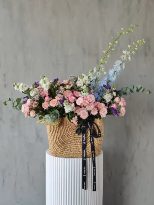 This beautiful bag for flowers is the perfect way to show your loved ones you are thinking of them. It is overflowing with a variety of fresh, colorful flowers, including roses, daisies and many more seasonal blooms. It is sure to make a lasting impression on anyone who receives it.